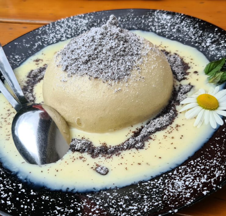 Germknoedel Sweet Austrian Dumpling Filled With Jam Served With Vanilla Sauce, Poppy Seeds And Butter
